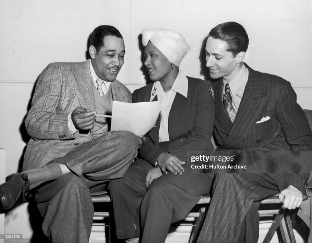 Jazz FriendsJanuary 1945: L-R: American jazz composer and band leader Duke Ellington (1899 - 1974), American jazz singer and composer Billie Holiday, and American jazz critic Leonard Feather review a piece of music. (Photo by Hulton Archive/Getty Images)