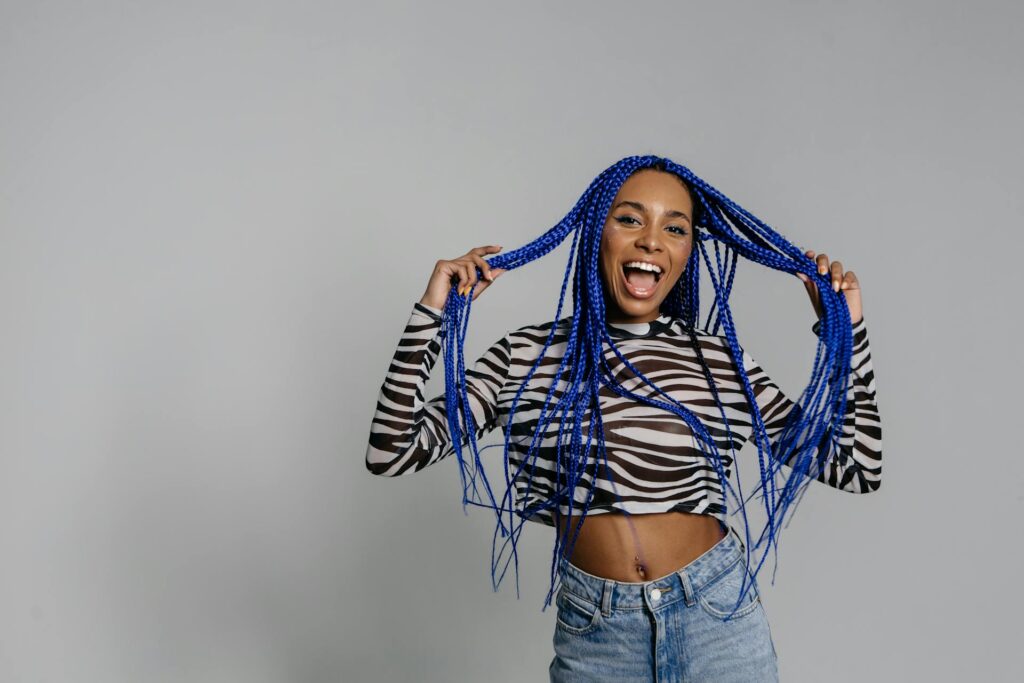 Photo by Pavel Danilyuk: https://www.pexels.com/photo/woman-with-blue-hair-looking-at-the-camera-with-her-mouth-open-8638541/