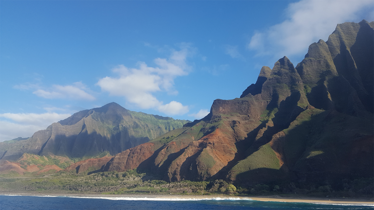 Cliffs on the west coast of Kauai, one of the islands of Hawaii, seen from the ocean.