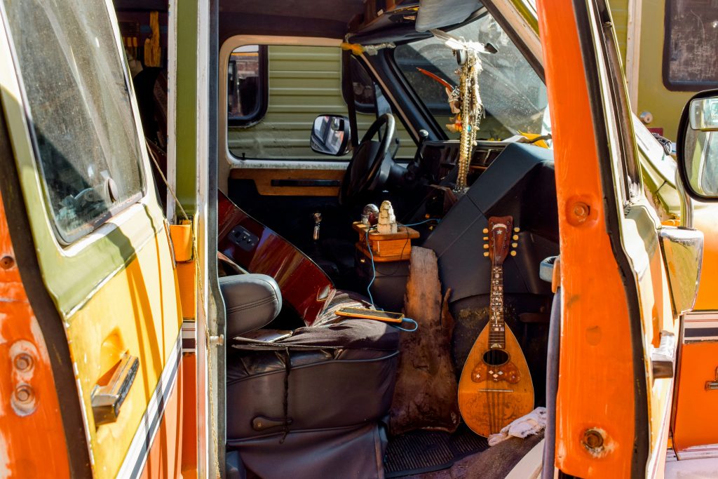 Inside of a van. Image courtesy of Unsplash.com. https://unsplash.com/photos/brown-acoustic-guitar-on-black-car-XWTDiusatVU
