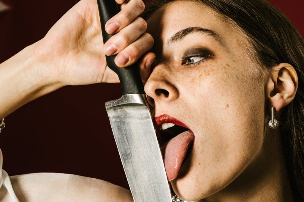 Crazy woman licking knife