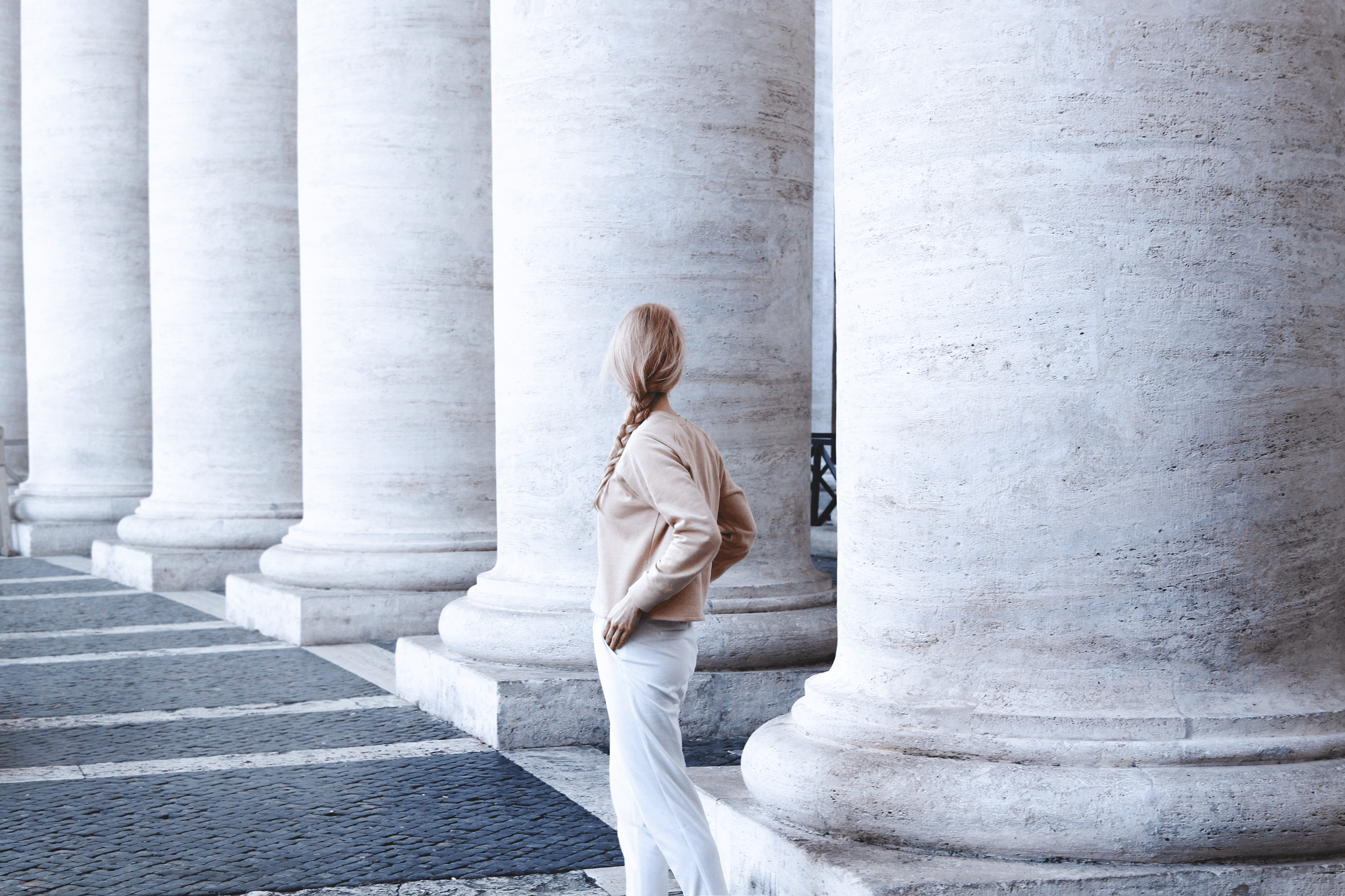 solo travel: woman standing by pillars in Rome