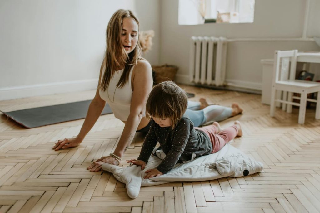 Woman and Child Doing Yoga for Benefits of Low Impact Exercises