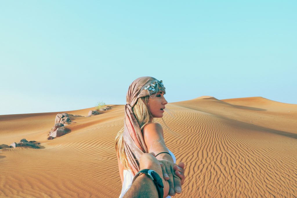 Woman walking in sand. Image courtesy of Unsplash.com. https://unsplash.com/photos/man-and-woman-holding-hands-while-in-desert-0IGhARplNzY