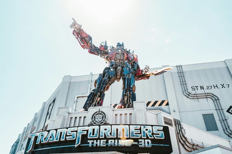 Optimus Prime statue at Transformers ride at Universal Studios, courtesy of Aditya Vyas on Unsplash. https://unsplash.com/photos/man-in-red-and-black-suit-statue-B9MULm2UZIk