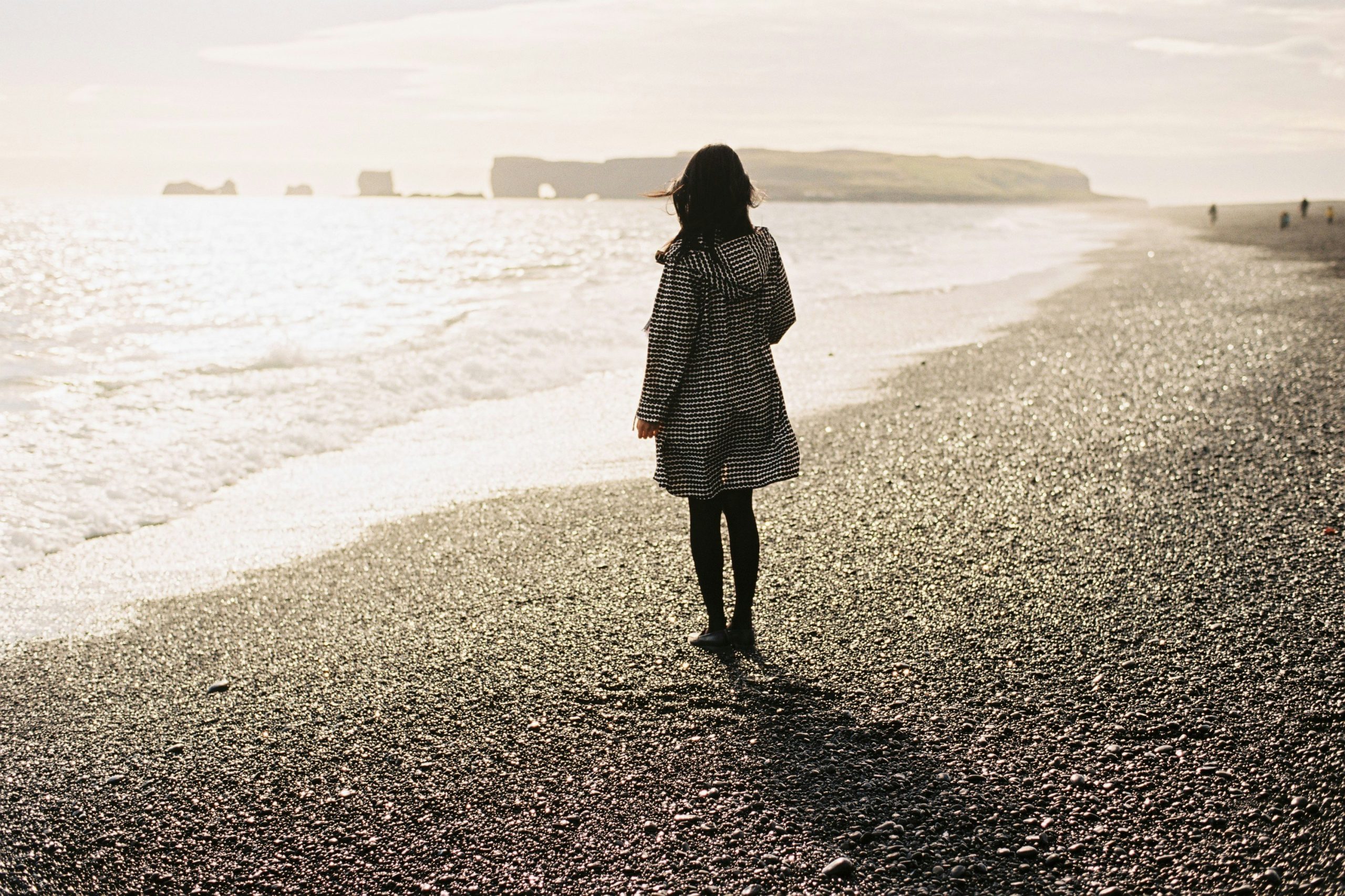 Alone Time: Woman standing alone at an Icelandic beach. 