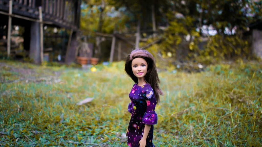 Brunette Barbie outside. Image courtesy of Unsplash.com. https://unsplash.com/photos/girl-in-blue-and-pink-floral-dress-standing-on-green-grass-field-during-daytime-mrKiZYakpLQ
