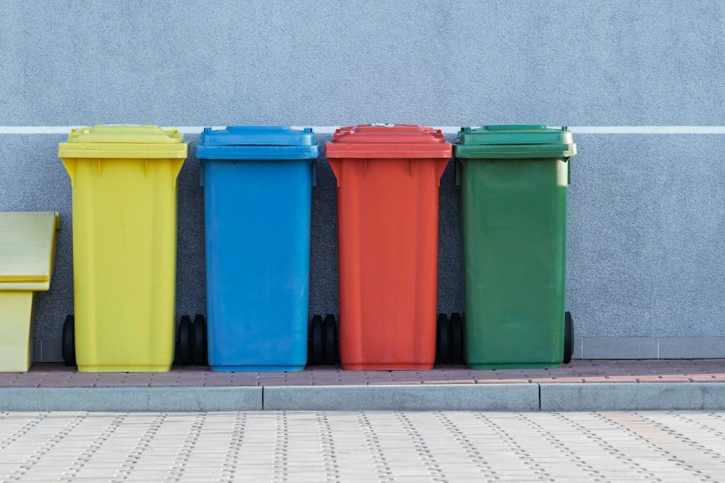 Recycling bins. Photo by Pawel_Czerwinski on Unsplash.com. https://unsplash.com/photos/four-assorted-color-trash-bins-beside-gray-wall-RkIsyD_AVvc
