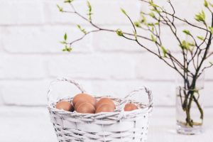 eggs in a basket with foliage. 