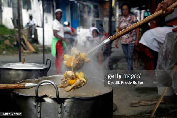 food in Colombia. MEDELLIN, COLOMBIA - APRIL 04: Supporters stir the sancocho during a rally of Colombia's vice-presidential candidate Francia Marquez of the Pacto Historico as part of the presidential election campaign on April 04, 2022 in Medellin, Colombia. Francia Marquez will run for Vice President along Presidential candidate Gustavo Petro of Pacto Historico.