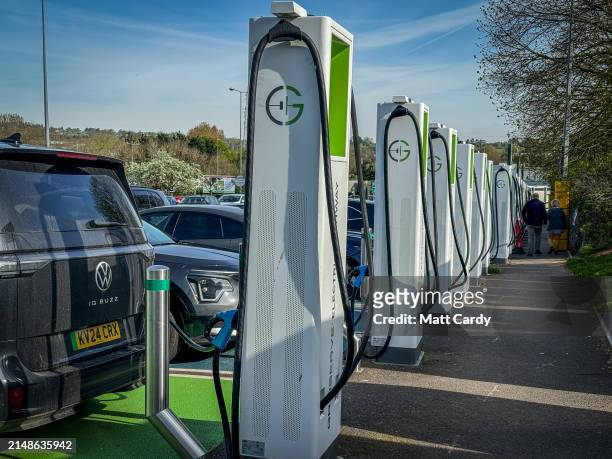 tech, telematics, insurance rates. EXETER, UNITED KINGDOM - APRIL 13: Electric cars including Teslas recharge at a charging area of a motorway service station on April 13, 2024 in Exeter, England. The European Union plans to ban all new sales of carbon-emitting petrol and diesel cars by 2035. Originally the UK planned to ban the sale of new petrol and diesel cars in Britain will by 2030, however this has recently put back still further. Critics of the laws have expressed concern that many internal combustion engined carbon polluting cars, lorries and vans will be still on the roads long after the ban on their sale. (Photo by Matt Cardy/Getty Images)
