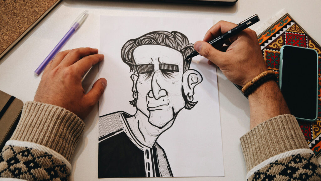 A person drawing a picture. Image courtesy of Unsplash.com. https://unsplash.com/photos/person-holding-pen-drawing-on-white-paper-A6XhSbJuLXk