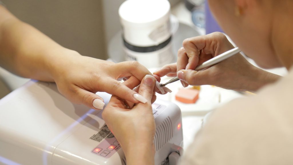 Someone getting a manicure. Image courtesy of Unsplash.com. https://unsplash.com/photos/a-woman-getting-her-nails-done-at-a-nail-salon-gb6gtiTZKB8