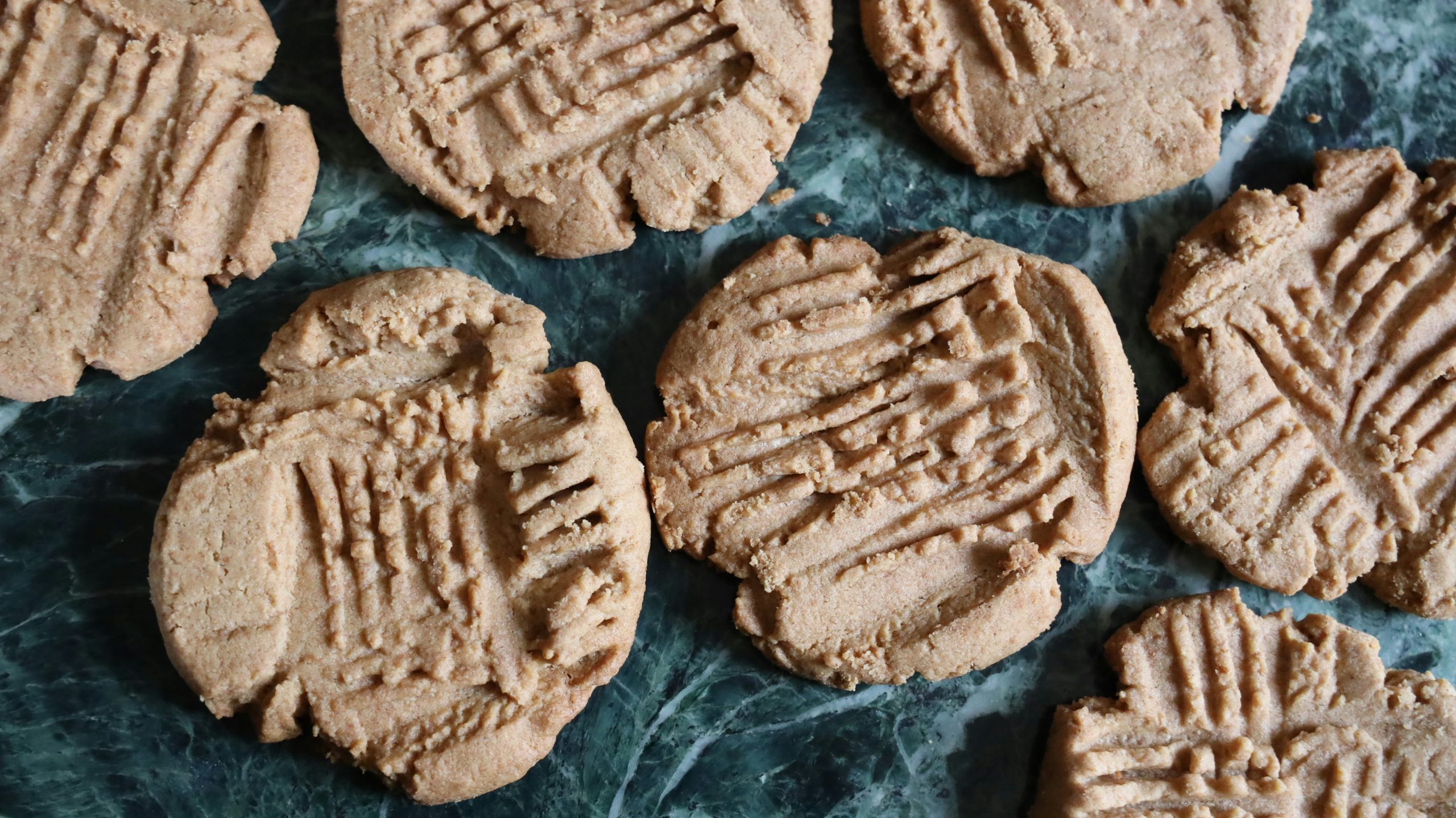Peanut butter cookies on a marble counter, a delectable dessert.