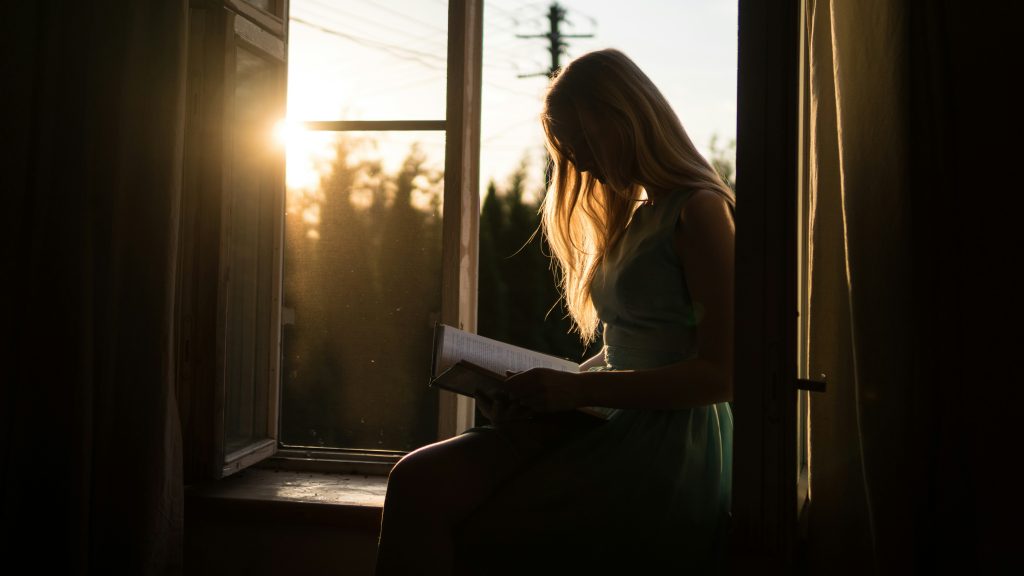 Woman reading. Photo by Yuri Efremov on Unsplash. https://unsplash.com/photos/woman-reading-book-while-sitting-at-window-lCAbfVDdI9Q