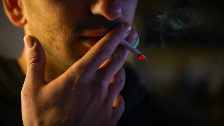 Man smoking. This is the featured image for the article on ADHD and smoking. Photo by Reza Mehrad on Unsplash. https://unsplash.com/photos/a-man-smoking-a-cigarette-in-the-dark-wQv94mB3TcY