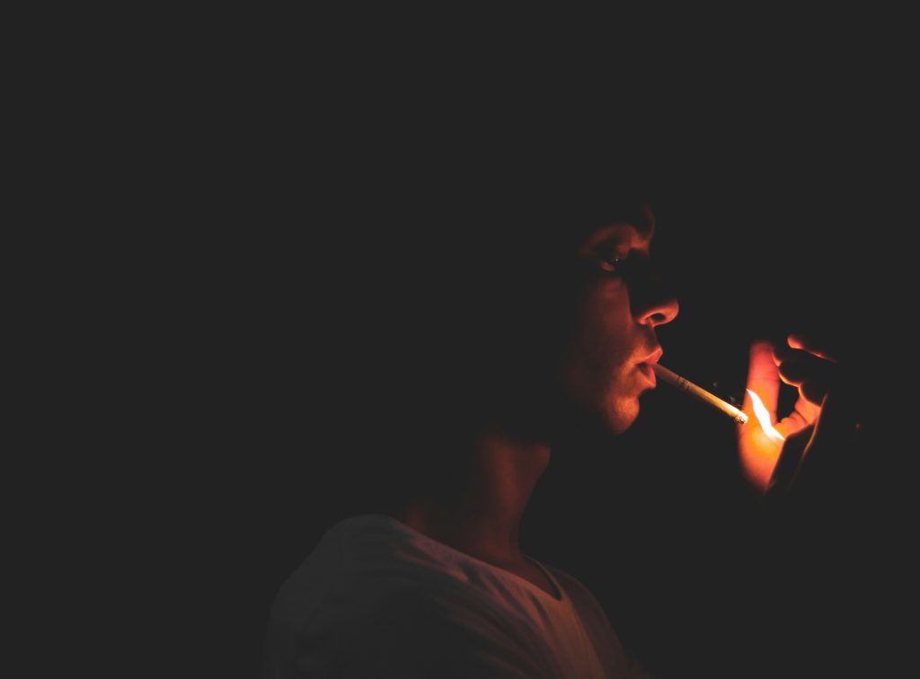 Man smoking. Photo by A B E D K A Y A L I on Unsplash. https://unsplash.com/photos/man-holding-lighter-c203mmajhag