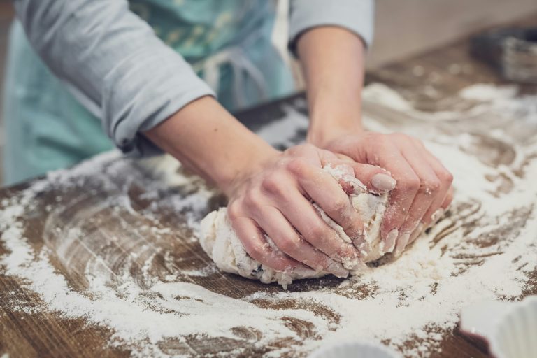 Person baking. This is the featured image for the article on puto. Photo by Theme Photos on Unsplash. https://unsplash.com/photos/person-standing-and-making-dough-Hx7xdwhj2AY