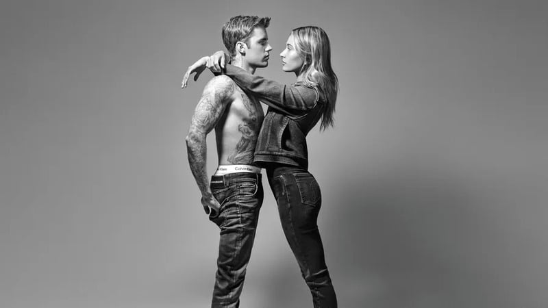 Justin Bieber held tightly by wife.