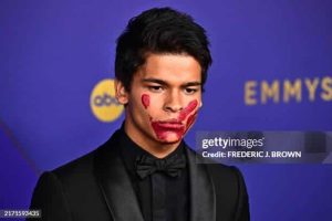 2024 Emmy nominee D'Pharaoh Woon-A-Tai wearing a red handprint painted over his mouth.