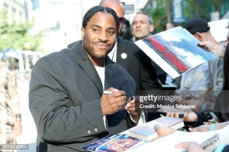 Denzel Washington's son Malcolm signing autographs at the premiere of The Piano Lesson. (Credit: Monica Schipper / Getty)