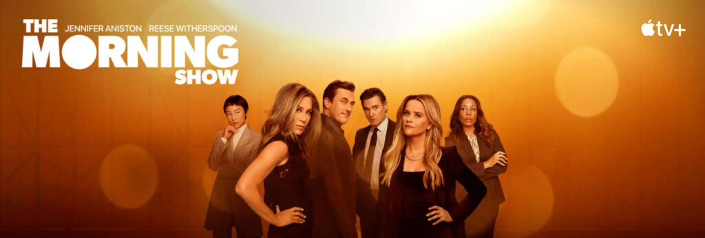 The Morning Show cast, including Jennifer Aniston and Reese Witherspoon, in a dramatic scene, representing this popular Apple TV+ show.