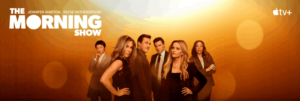 The Morning Show cast, including Jennifer Aniston and Reese Witherspoon, in a dramatic scene, representing this popular Apple TV+ show.