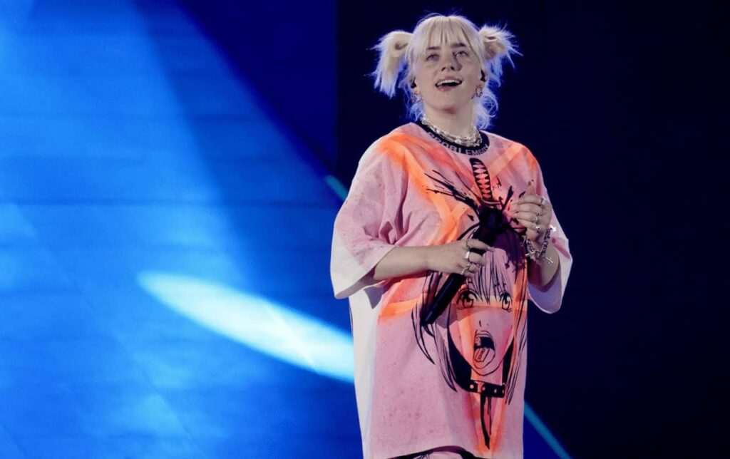 Billie Eilish performing on stage, a top streaming artist on Apple Music.