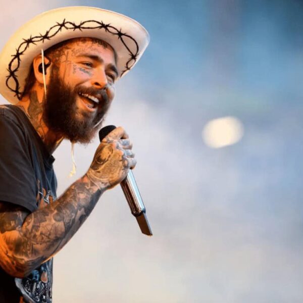 Post Malone performing on stage in a cowboy hat, a top streaming artist on Apple Music.
