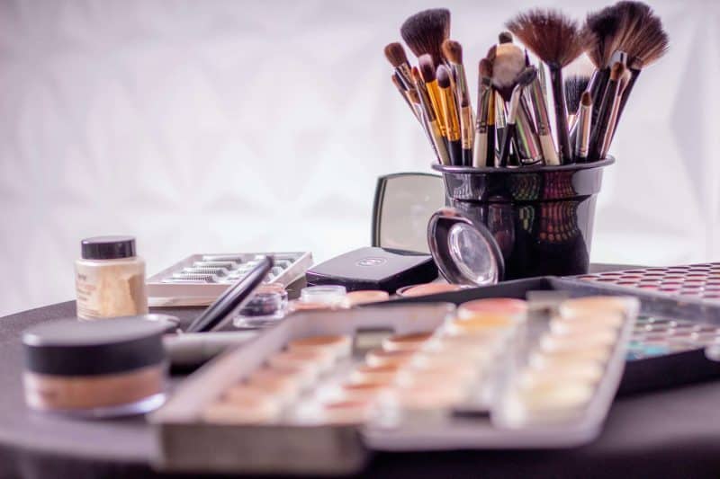 Close-up of a professional makeup brush set and cosmetics on a table for beauty use. Beauty Products.