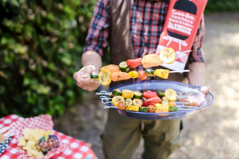 Vibrant vegetable skewers being prepared at an outdoor barbecue during summer. Memorial Day BBQ, Plant-based