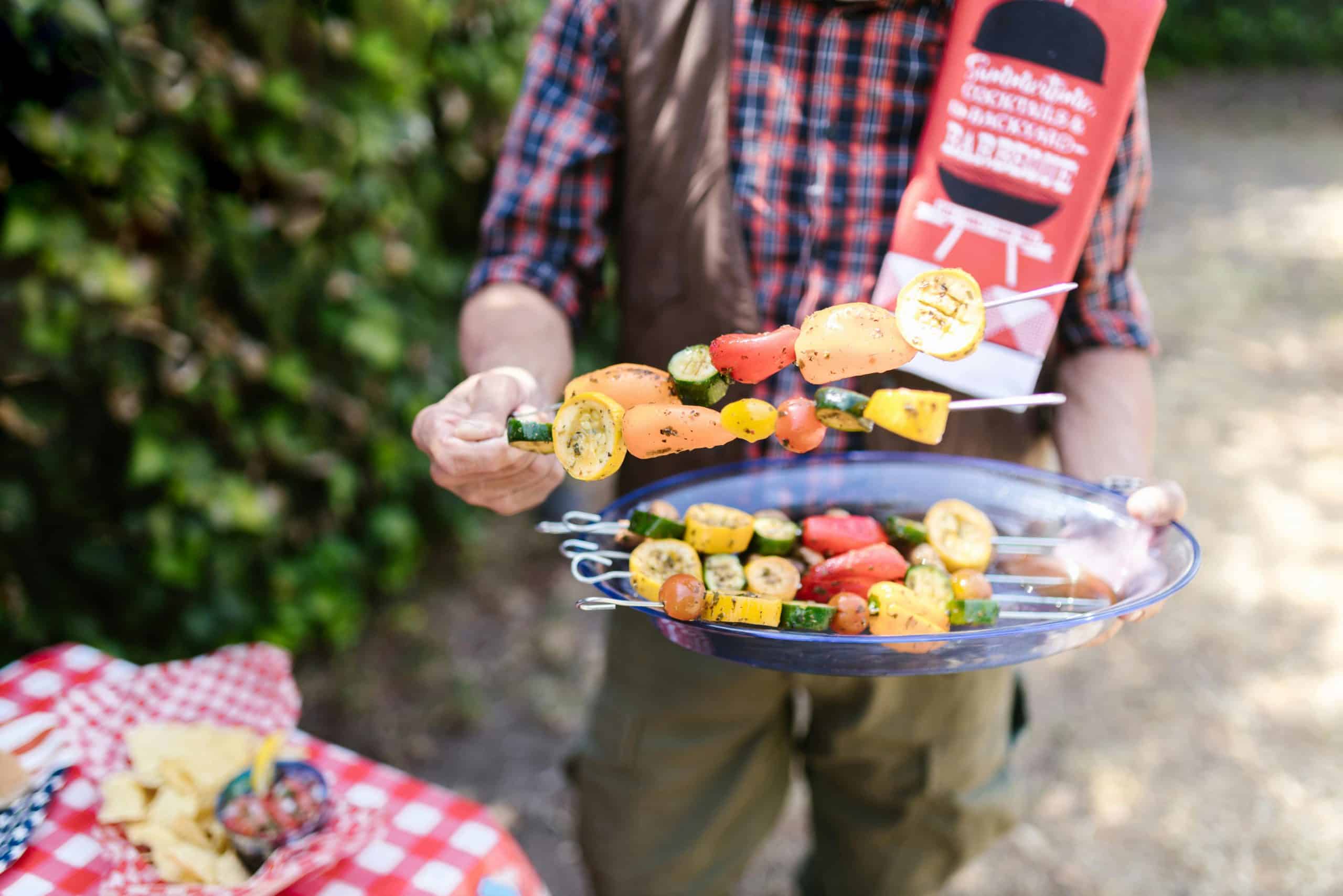 Vibrant vegetable skewers being prepared at an outdoor barbecue during summer. Memorial Day BBQ, Plant-based