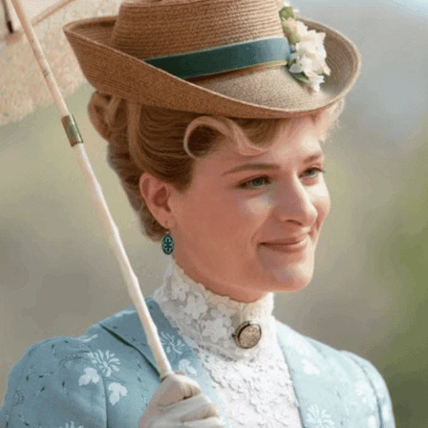 close-up of Marian, smiling, with a garden in the background