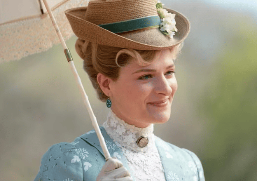 close-up of Marian, smiling, with a garden in the background