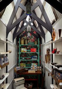 Interior of a charming small shop displaying various items, including some overrated products with vintage-style decor and cozy ambiance.