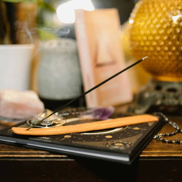 A tranquil setting featuring incense, crystals, and a glowing lamp for spiritual rituals. healing. mercury in cancer