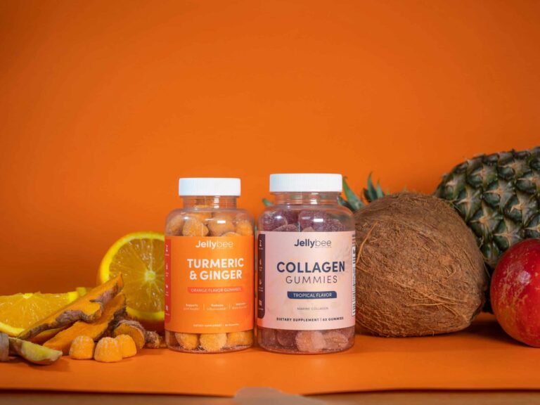 Colorful tropical beauty supplements in gummy form, surrounded by fresh fruits like coconut, pineapple, and orange.