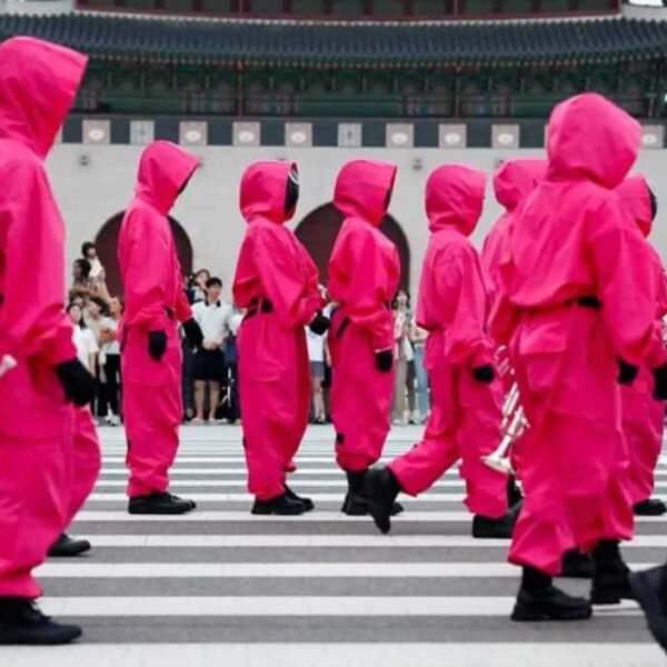Performers dressed as "Squid Game" soldiers march in a parade through central Seoul.