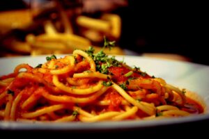 A plate of spaghetti with tomato sauce and parsley, global cuisine