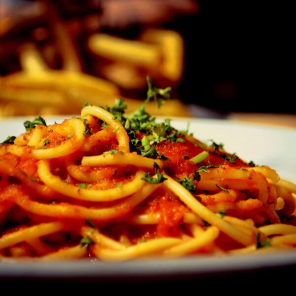 A plate of spaghetti with tomato sauce and parsley, global cuisine
