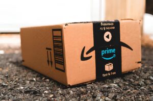 medium amazon prime day package laid on gravel of a driveway in front of a garage