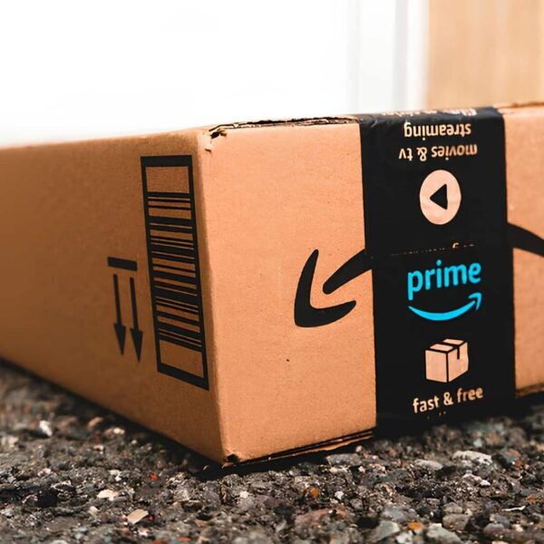 medium amazon prime day package laid on gravel of a driveway in front of a garage