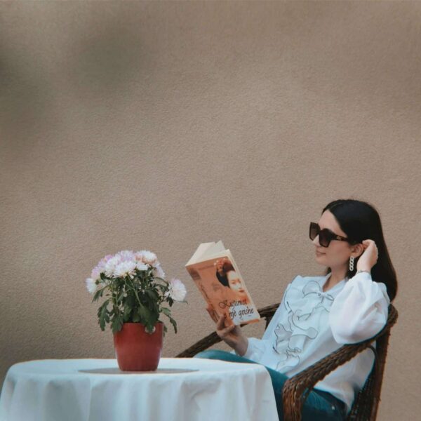 Solo date, a person sitting at a table reading a book