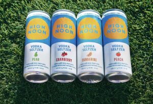 screenshot of the promotional image of four high noon flavors laying on green grass