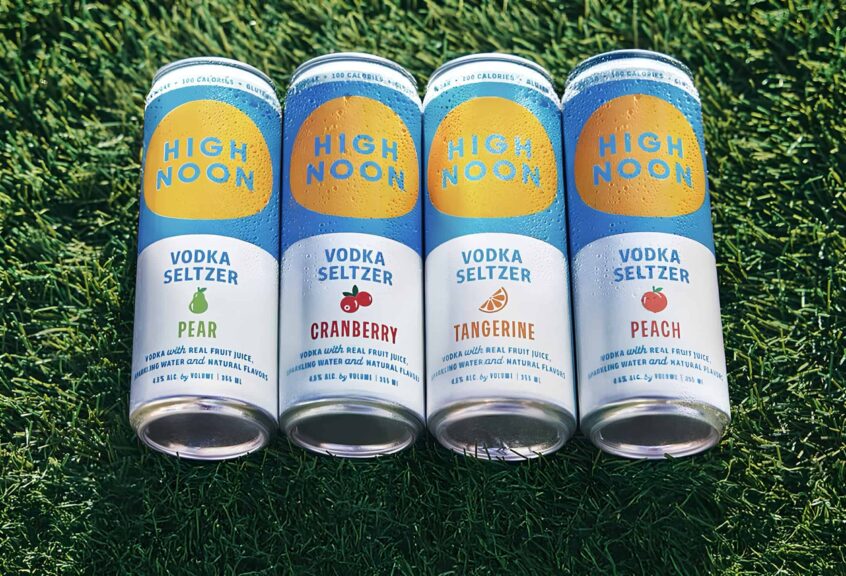 screenshot of the promotional image of four high noon flavors laying on green grass