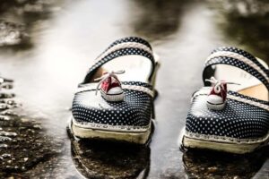 This is an image of clogs outside after a rainy day. The clogs have little sneakers on top of them. Slip-on clogs such as these can be both comfortable and stylish.