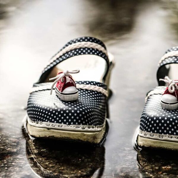 This is an image of clogs outside after a rainy day. The clogs have little sneakers on top of them. Slip-on clogs such as these can be both comfortable and stylish.
