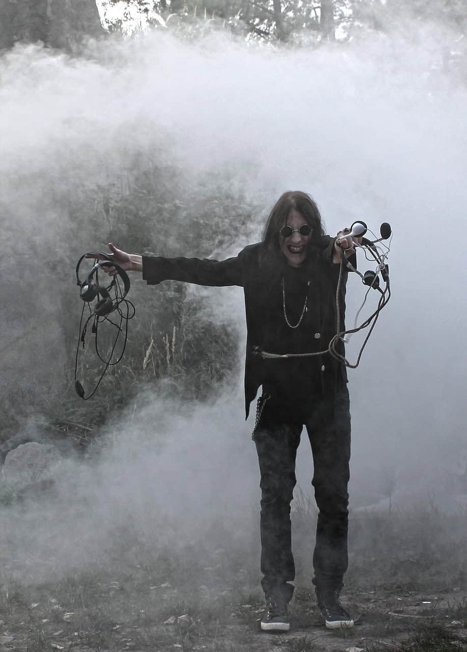 Ozzy Osbourne surrounded by smoke, holding cables with a chaotic grin — a visual that captures the rock legend’s wild energy and hints at his unpredictable food favorites.