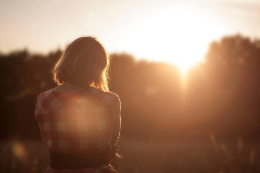 This is a photo of a woman watching a sunset. It demonstrates how taking alone time within a relationship can work.