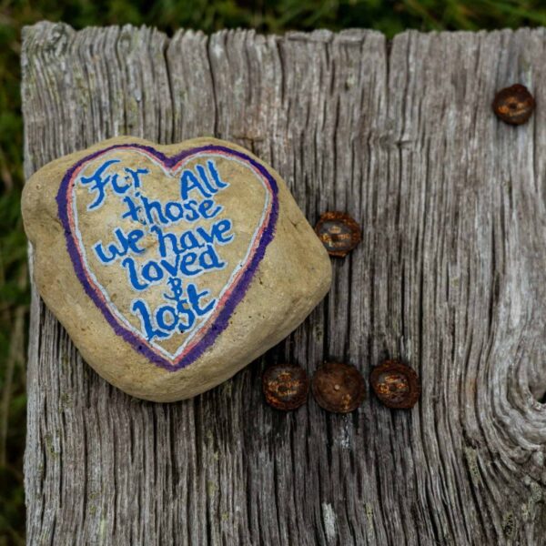 Grief: A heart-shaped rock with the words "For all those we have loved & Lost" painted on it.